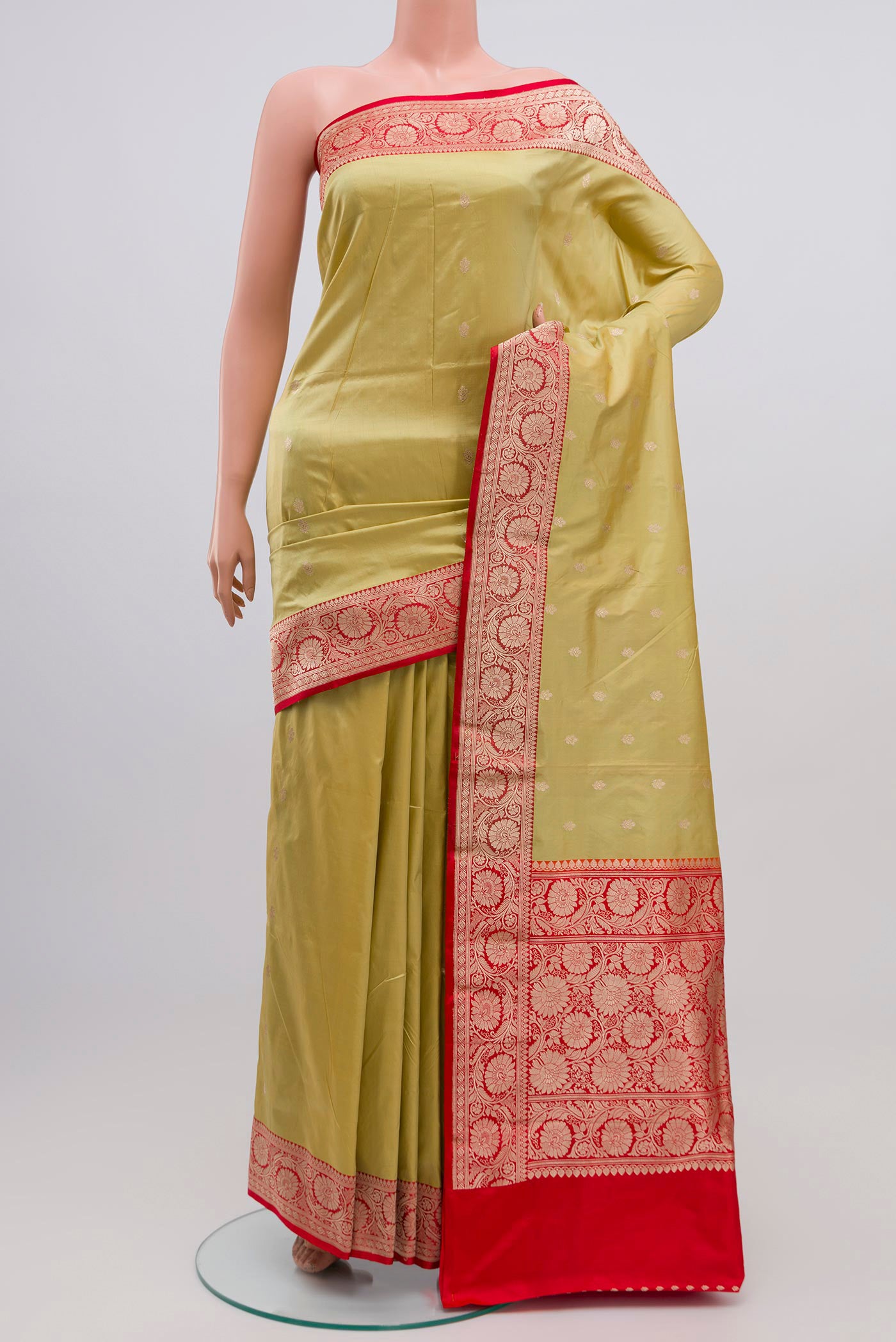 Pista Green Banarasi Katan Silk Saree with Zari Butta on the body and Zari Border.  displayed on a mannequin
