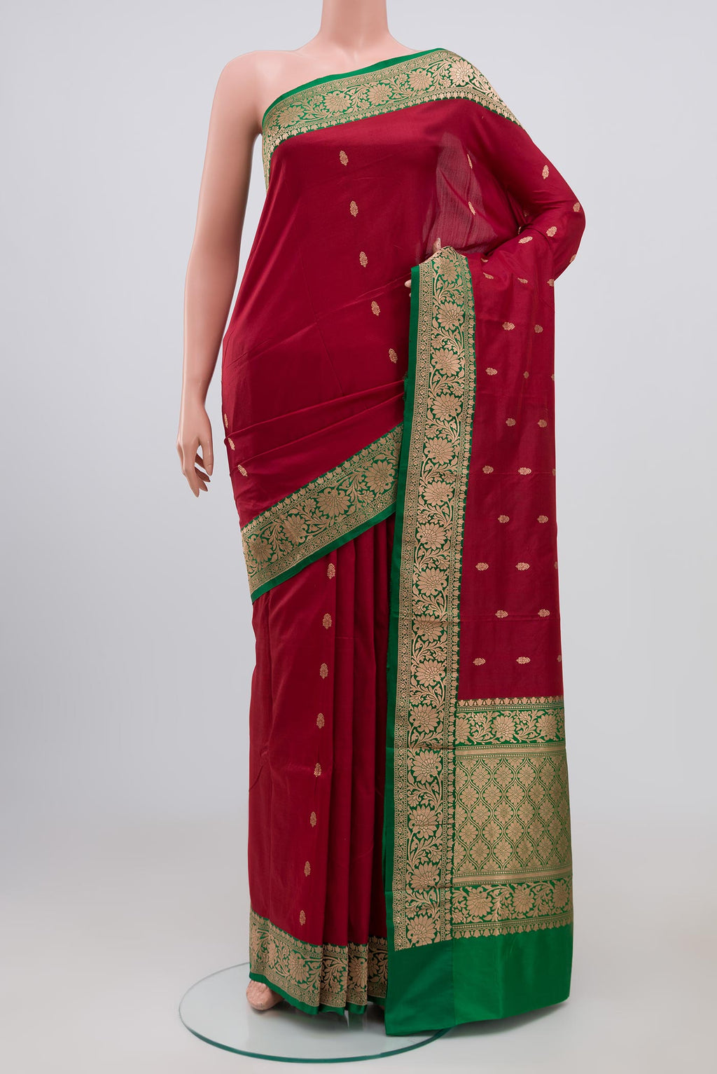 Maroon Banarasi Katan Silk Saree with Zari Butta on the body and Zari Border.  displayed on a mannequin