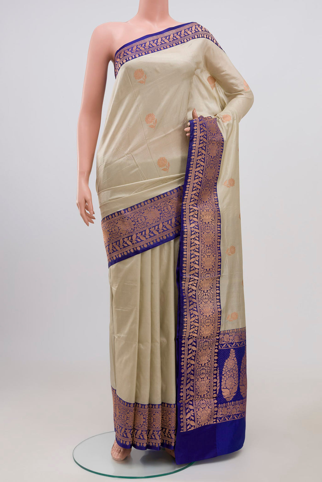 Cream Banarasi Katan Silk Saree with Zari Butta on the body and Zari Border.  displayed on a mannequin
