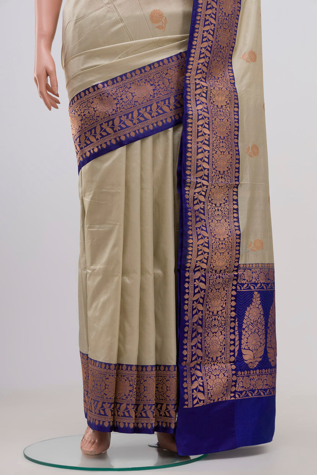 Pleats and pallu of Cream Banarasi Katan Silk Saree with Zari Butta on the body and Zari Border. 