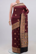 Maroon Banarasi Katan Silk Saree with Zari Butta on the body and Zari Border.  displayed on a mannequin