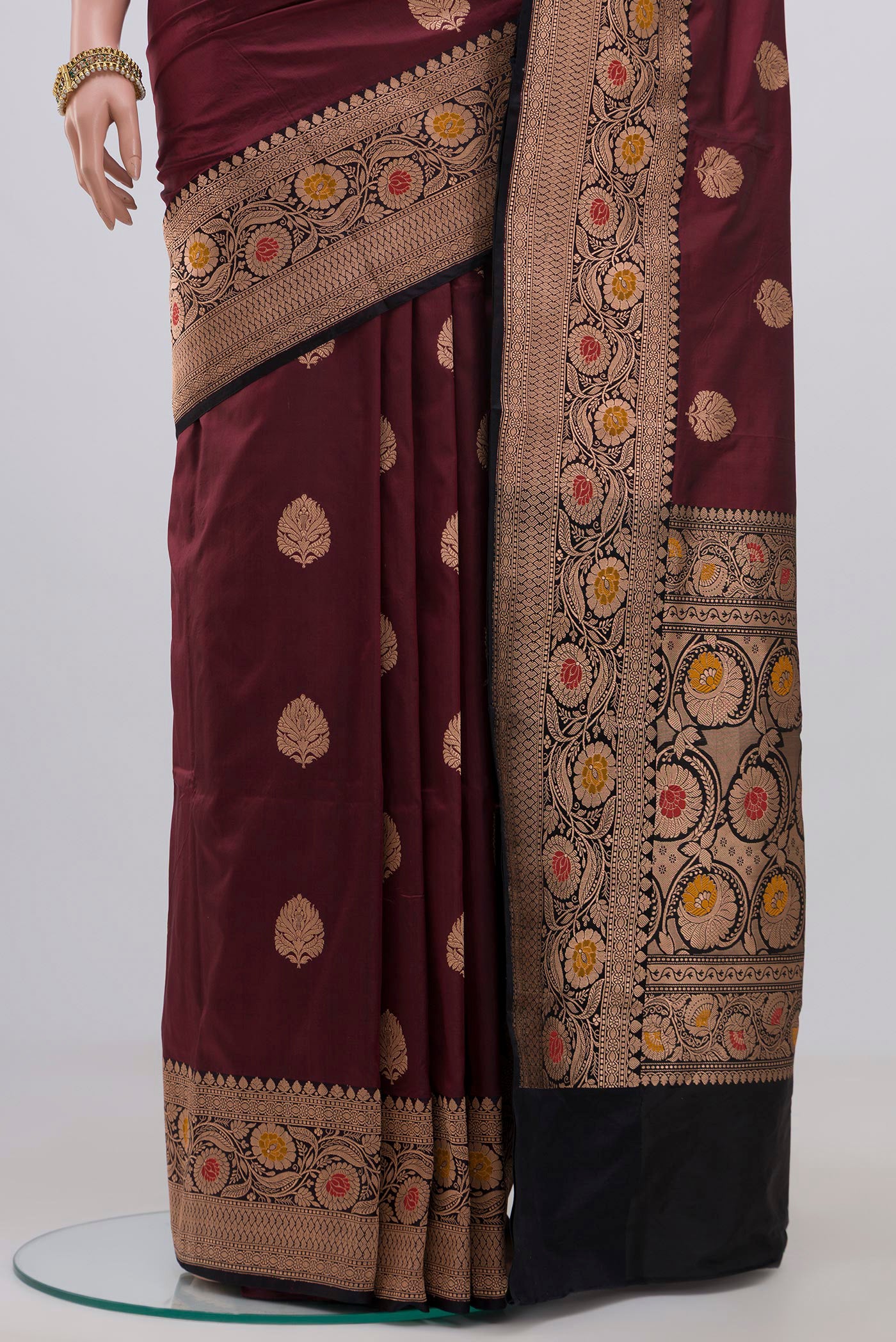 Pleats and pallu of Maroon Banarasi Katan Silk Saree with Zari Butta on the body and Zari Border. 