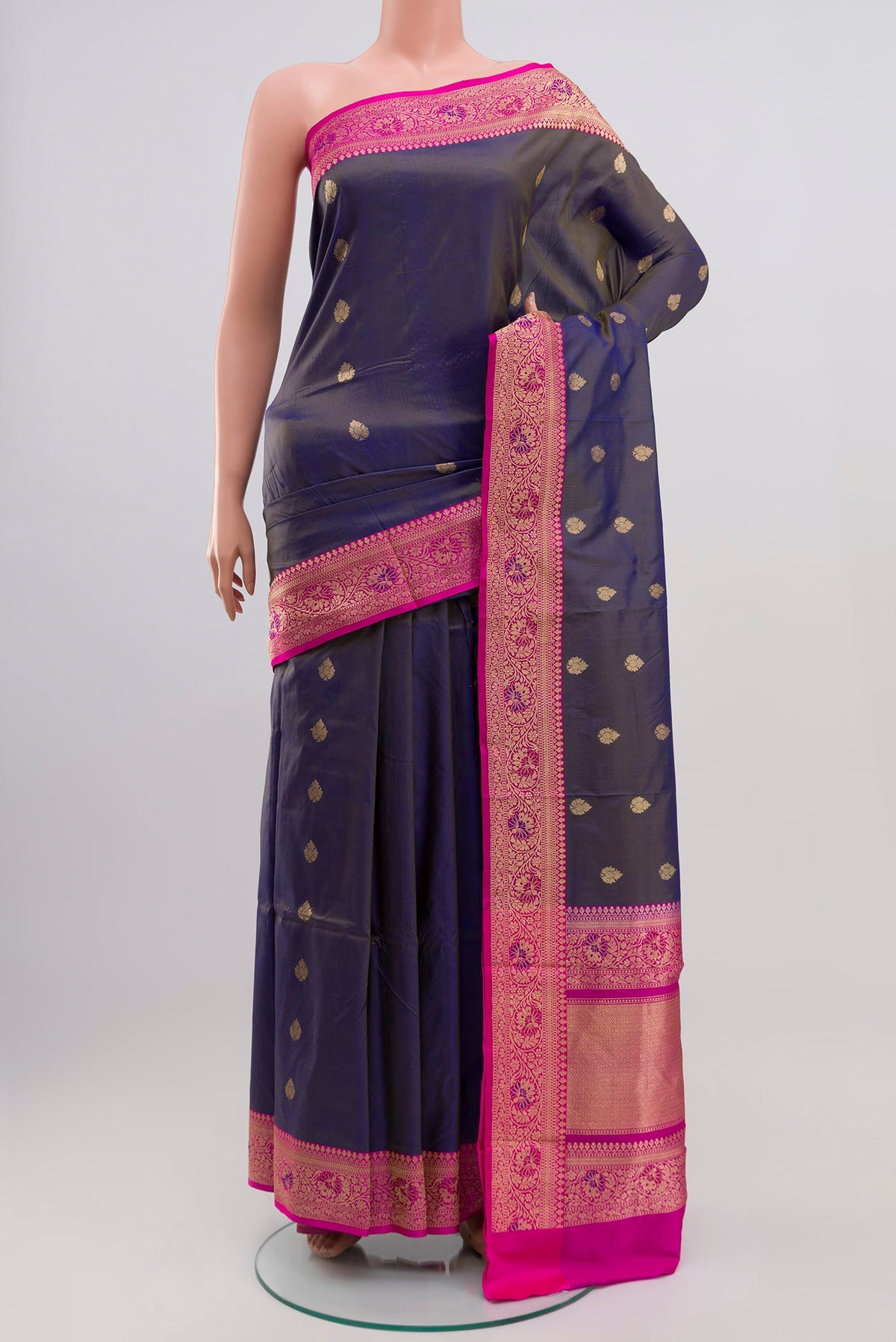 Blue Grey Banarasi Katan Silk Saree with Zari Butta on the body and Zari Border.  displayed on a mannequin
