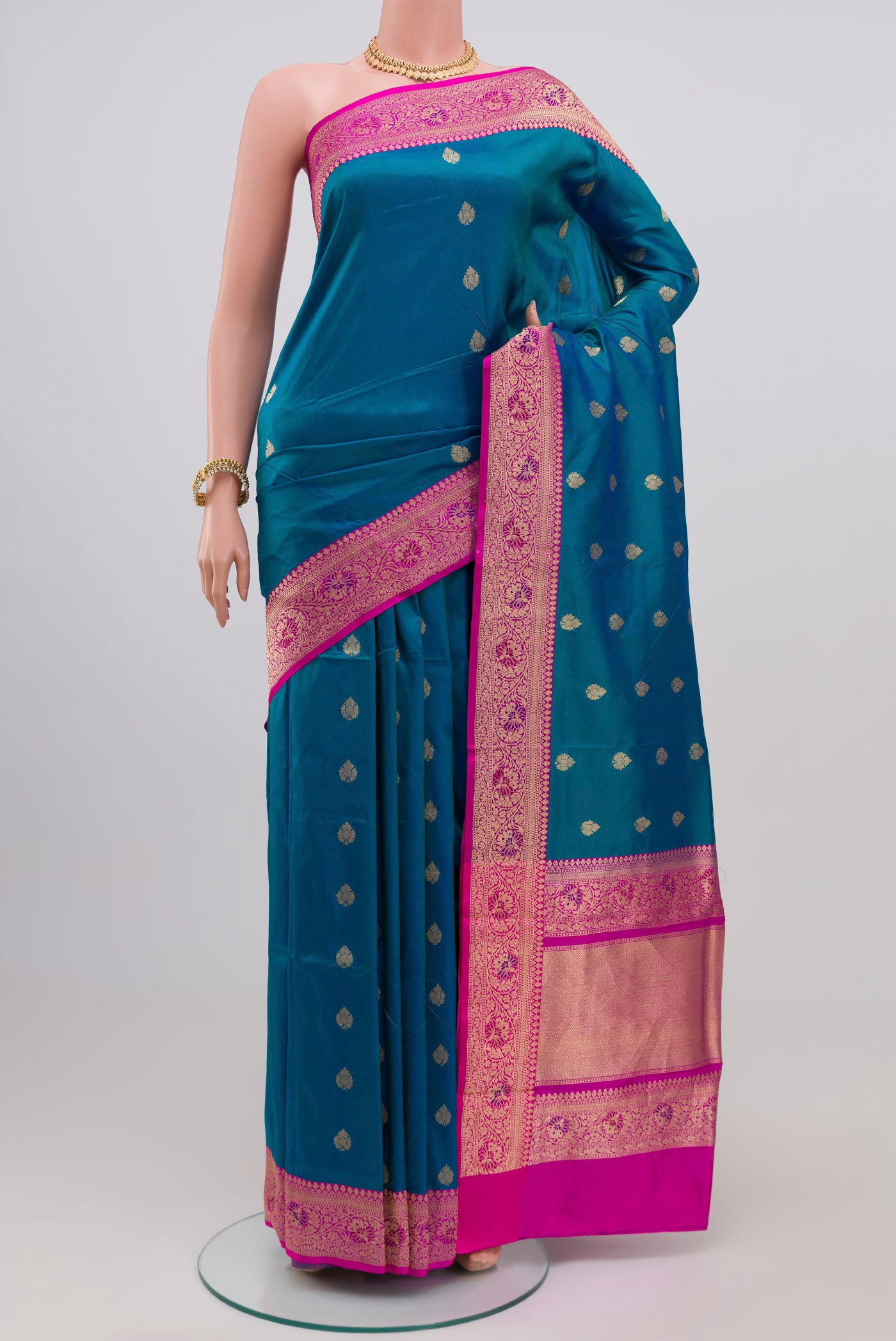 Blue Banarasi Katan Silk Saree with Zari Butta on the body and Zari Border.  displayed on a mannequin