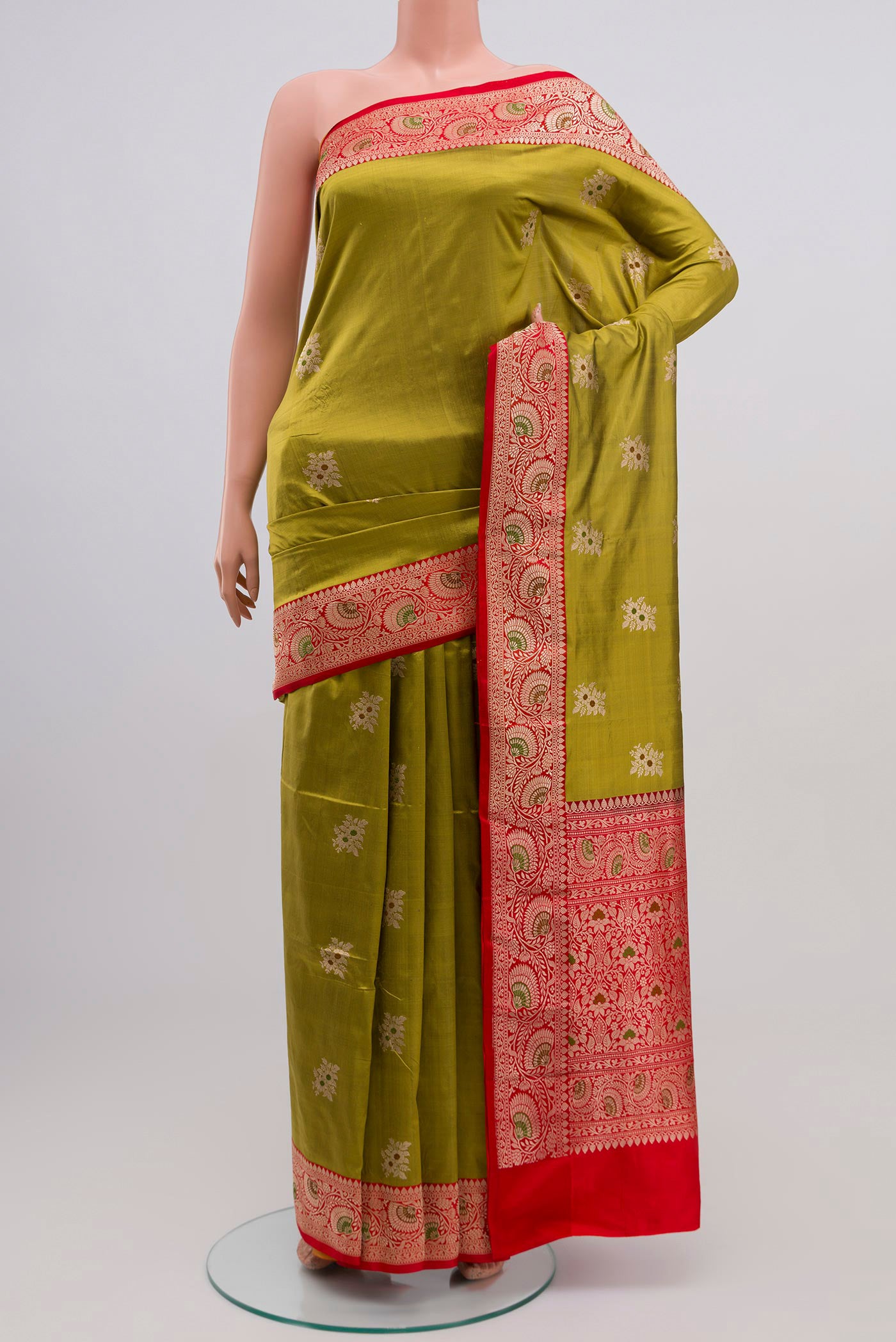 Green Banarasi Katan Silk Saree with Zari Butta on the body and Zari Border.  displayed on a mannequin
