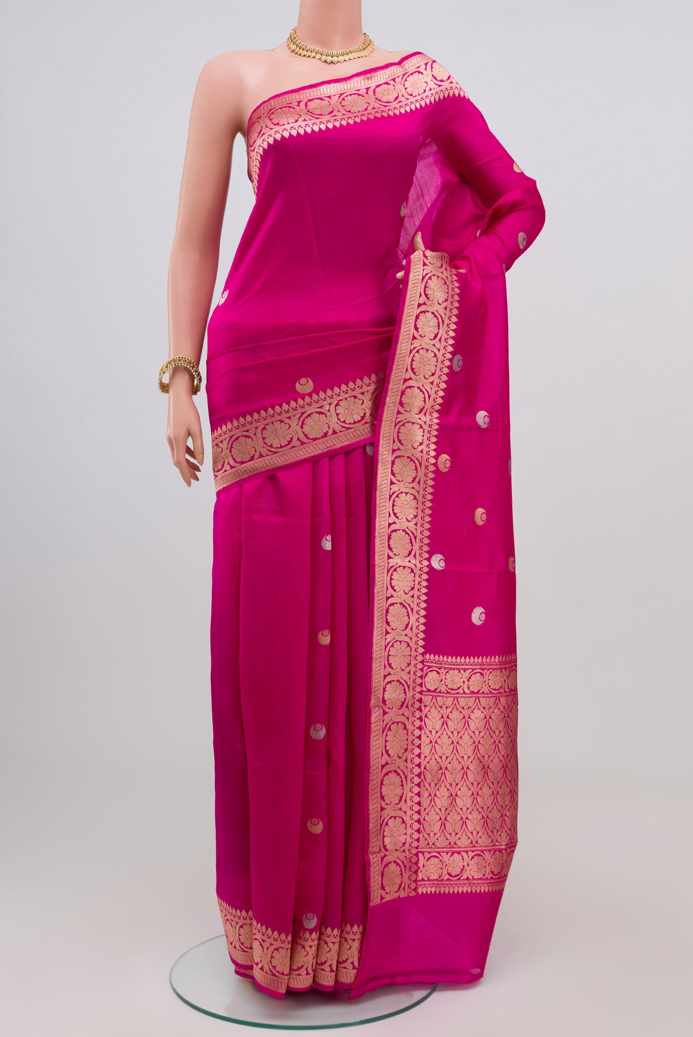 Dark Pink Banarasi Katan Silk Saree with Zari Butta on the body and Zari Border.  displayed on a mannequin