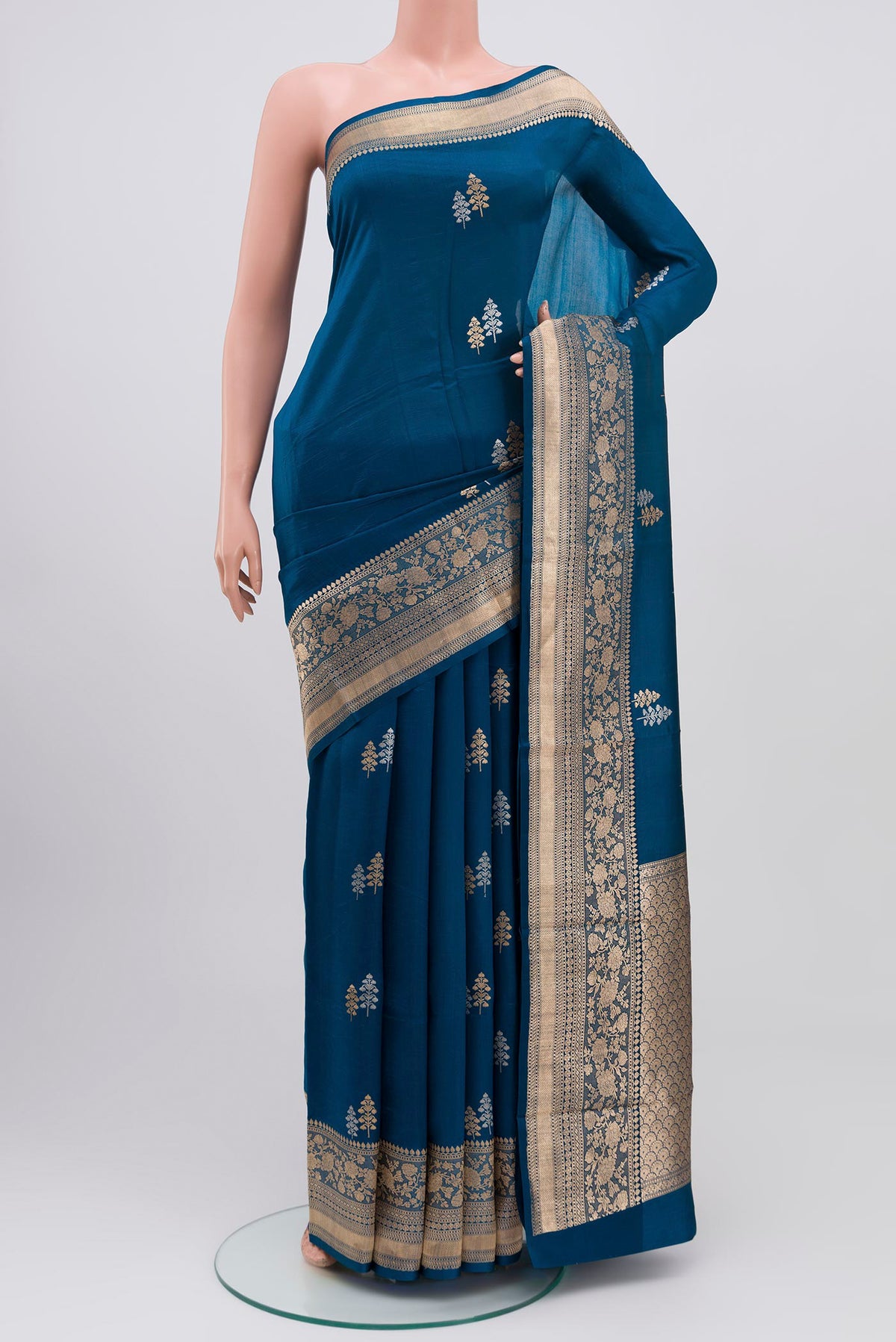 Blue Banarasi Katan Silk Saree with Zari Butta on the body and Zari Border.  displayed on a mannequin