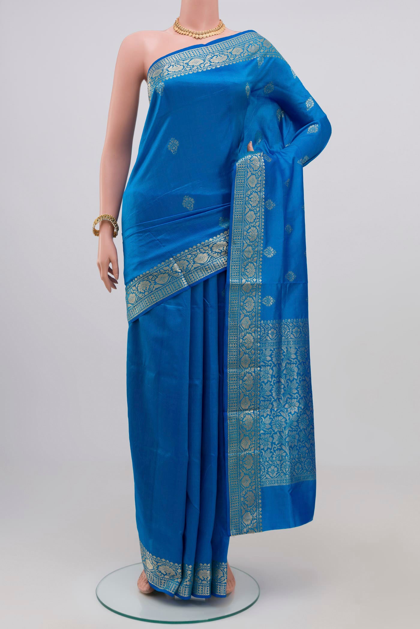 Royal Blue Banarasi Katan Silk Saree with Zari Butta on the body and Zari Border.  displayed on a mannequin