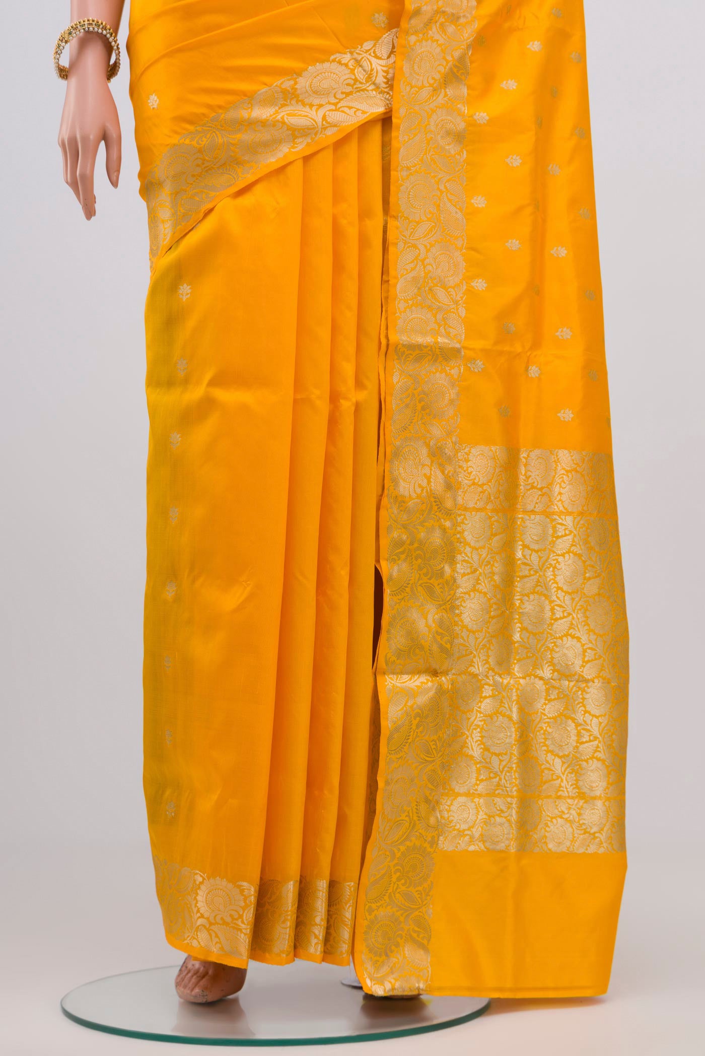 Pleats and pallu of Yellow Banarasi Katan Silk Saree with Zari Butta on the body and Zari Border. 