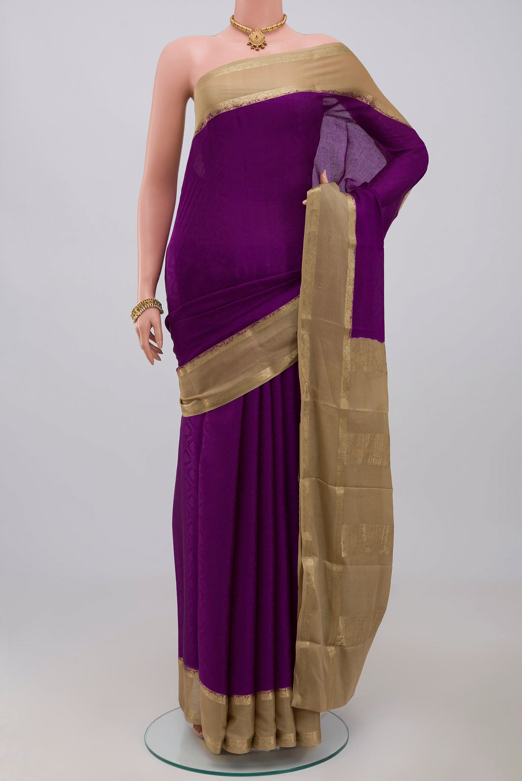 Purple Crepe Saree with Jacquard design on the body and Thin Zari Line.  displayed on a mannequin