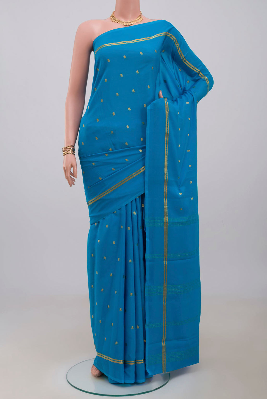 Blue Mysore Crepe Saree with Zari Butta on the body and Plain Border.  displayed on a mannequin
