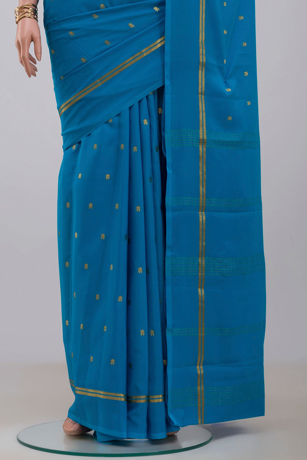 Pleats and pallu of Blue Mysore Crepe Saree with Zari Butta on the body and Plain Border. 