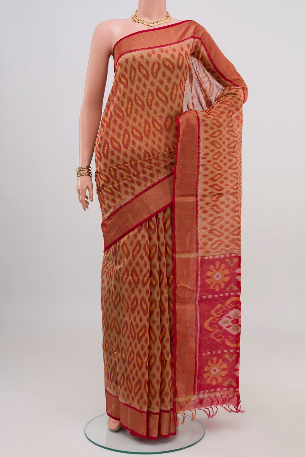 Beige Silk Cotton Saree with Ikat design on the body and Zari Border.  displayed on a mannequin