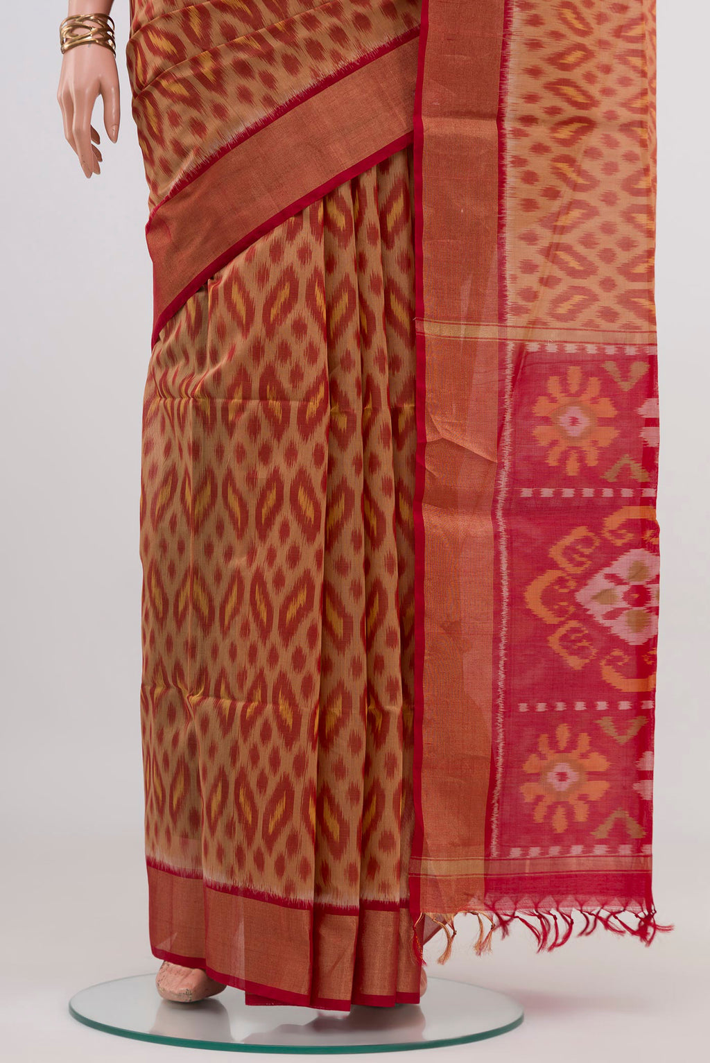 Pleats and pallu of Beige Silk Cotton Saree with Ikat design on the body and Zari Border. 