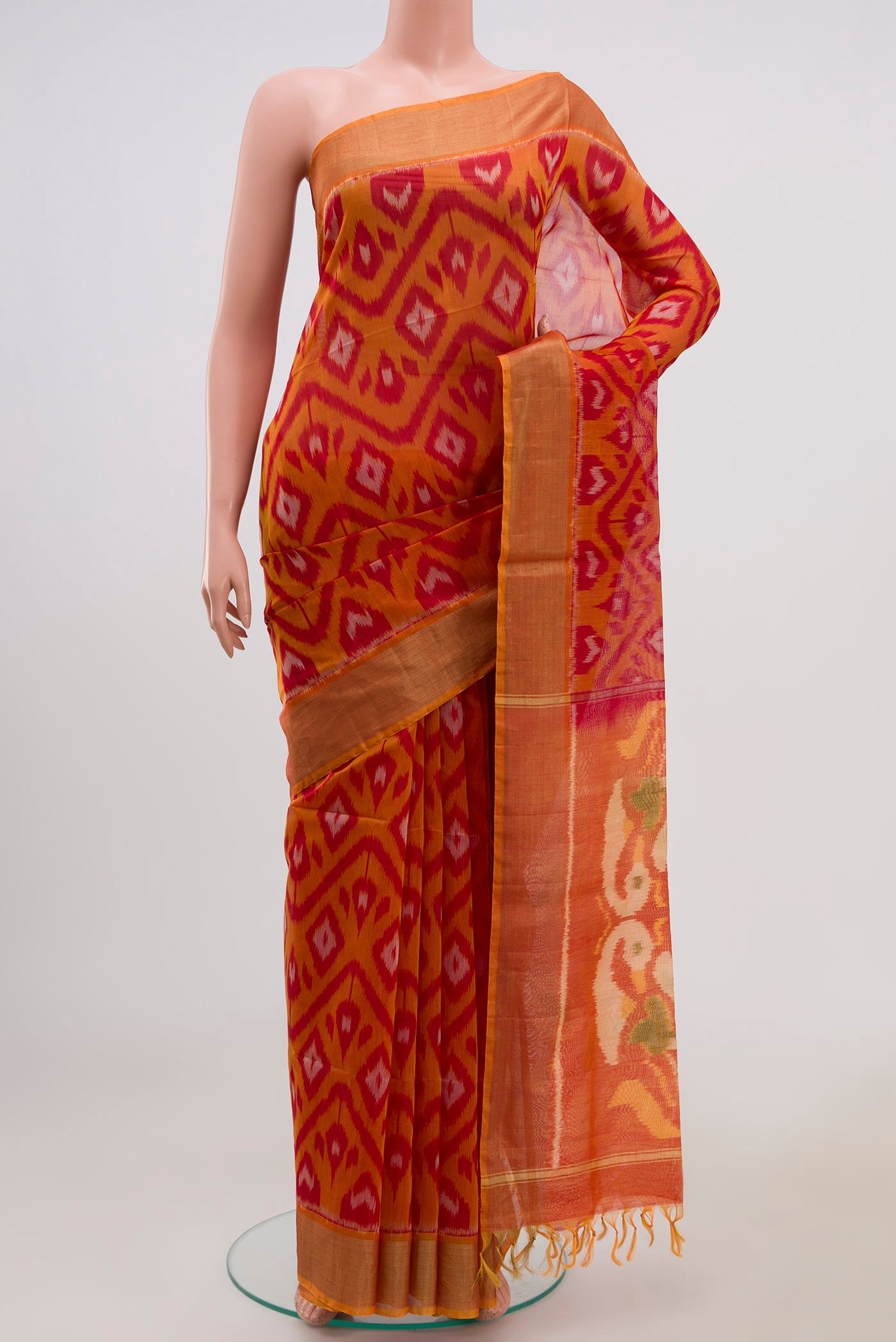 Red Coimbatore Silk Cotton Saree with Ikat Print on the body and Zari Border.  displayed on a mannequin