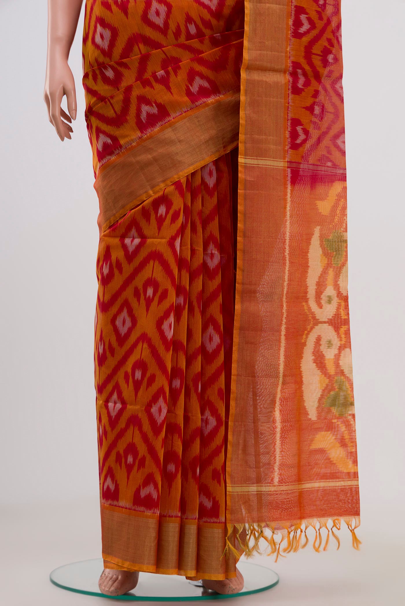Pleats and pallu of Red Coimbatore Silk Cotton Saree with Ikat Print on the body and Zari Border. 