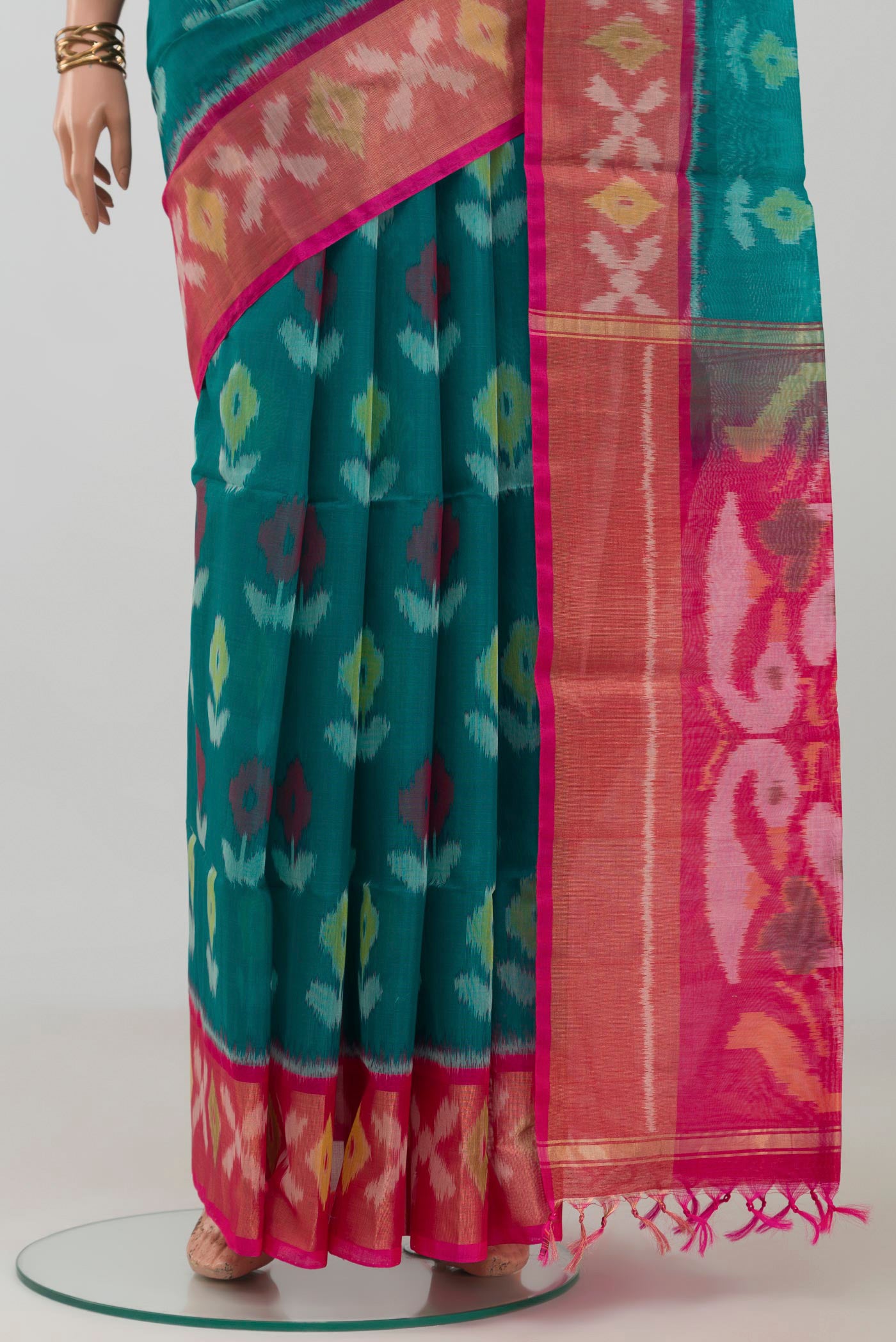 Pleats and pallu of Green Silk Cotton Saree with Ikat design on the body and Zari Border. 