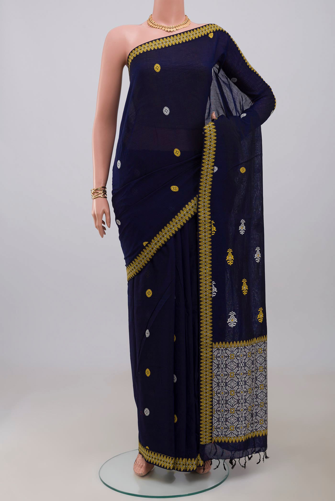Blue Assam Cotton Saree with Thread Butta on the body and Thread Border.  displayed on a mannequin