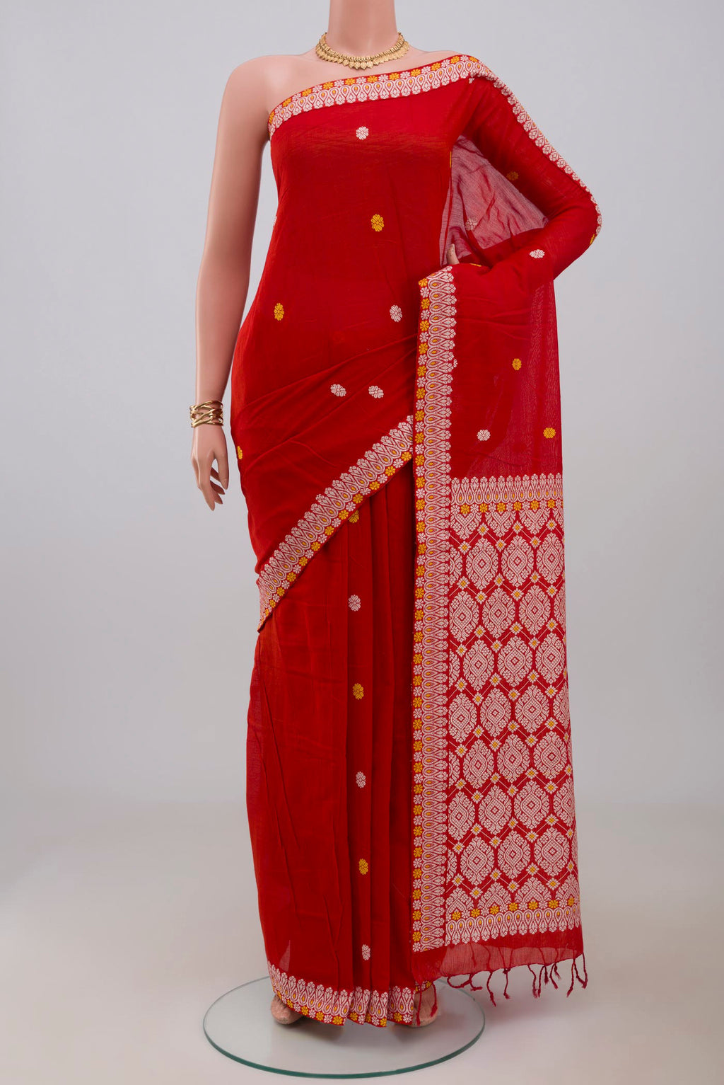 Red Assam Cotton Saree with Thread Butta on the body and Thread Border.  displayed on a mannequin