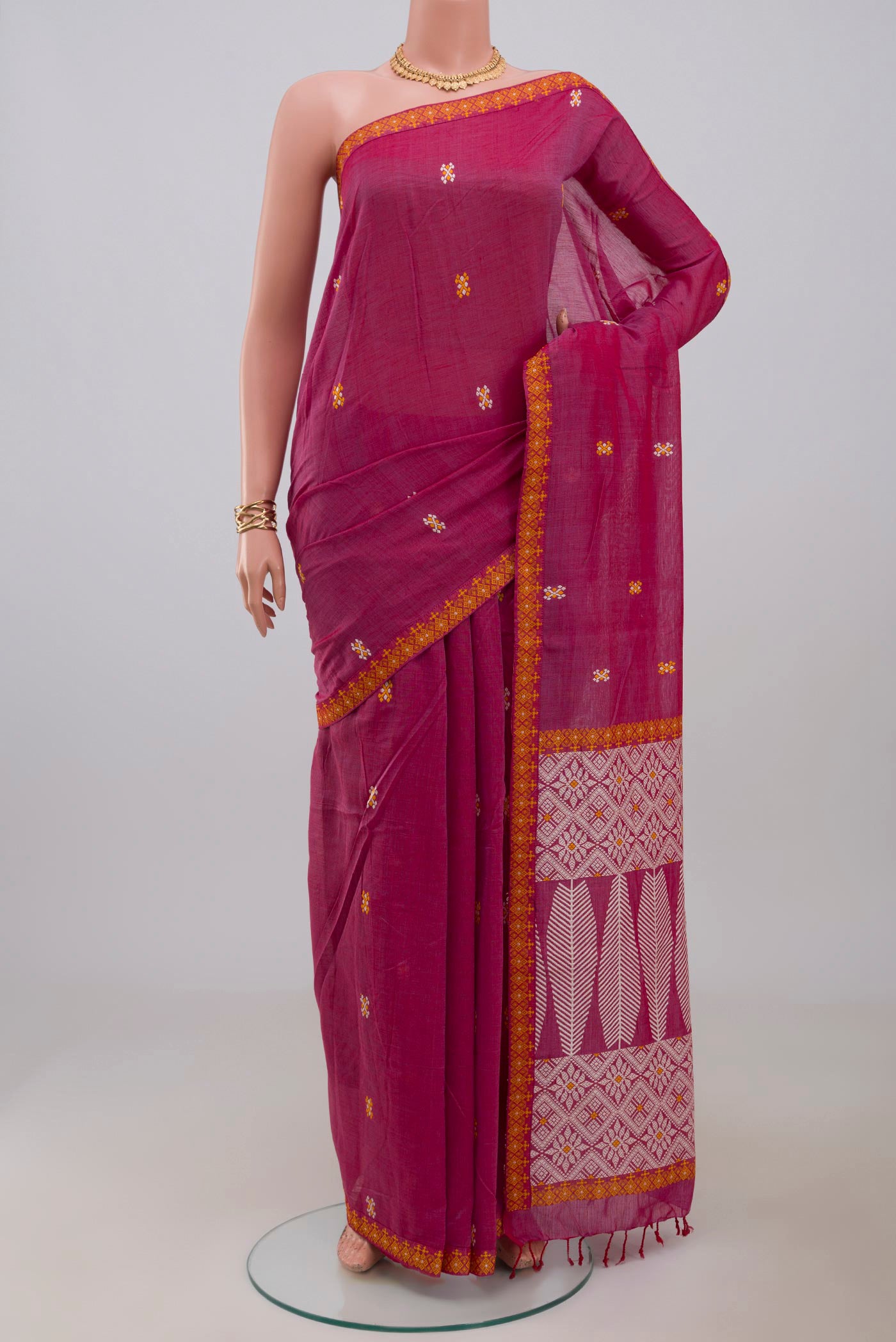 Pink Assam Cotton Saree with Thread Butta on the body and Thread Border.  displayed on a mannequin