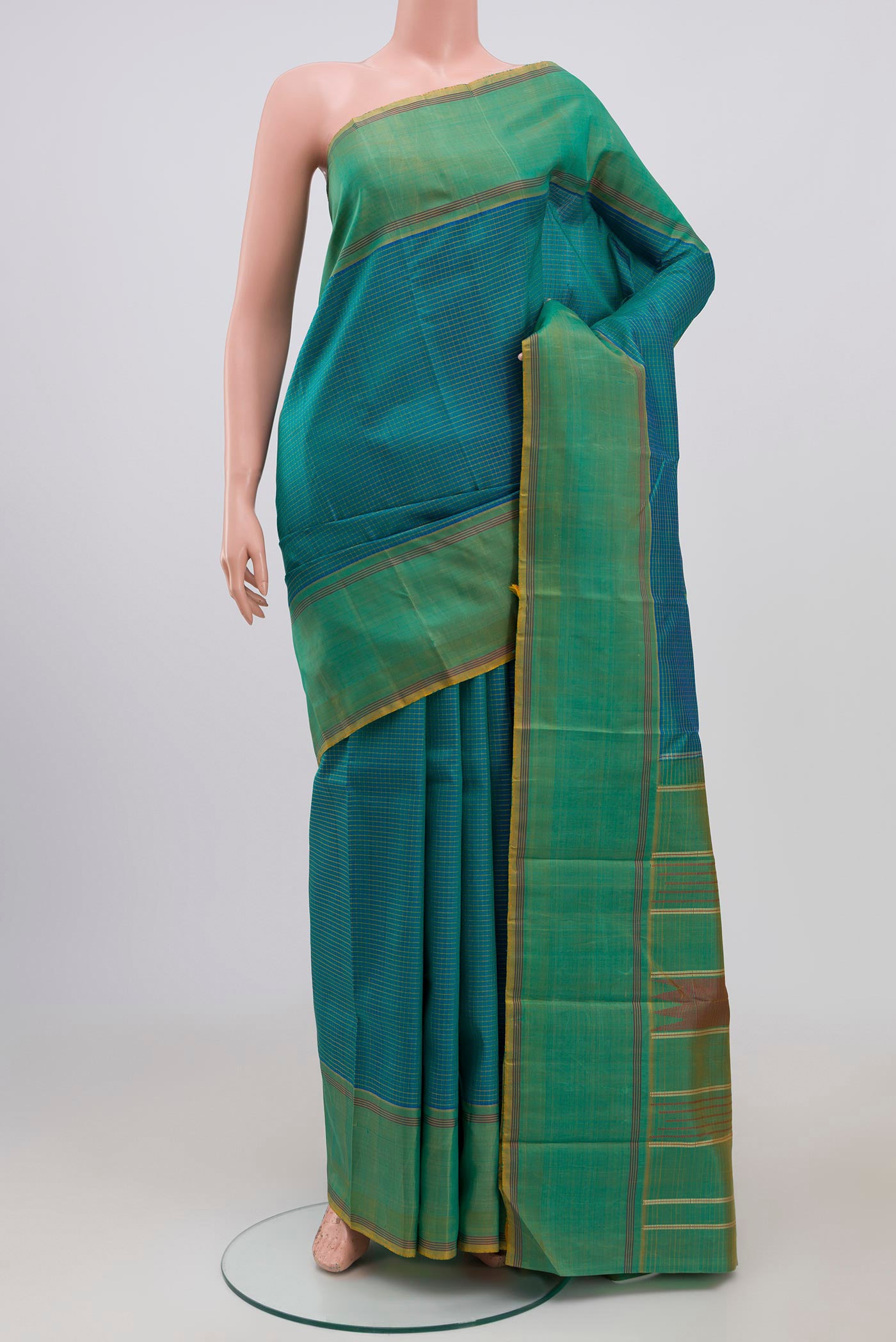 Blue Kanchipuram Saree with Checked design on the body and Thread Border.  displayed on a mannequin