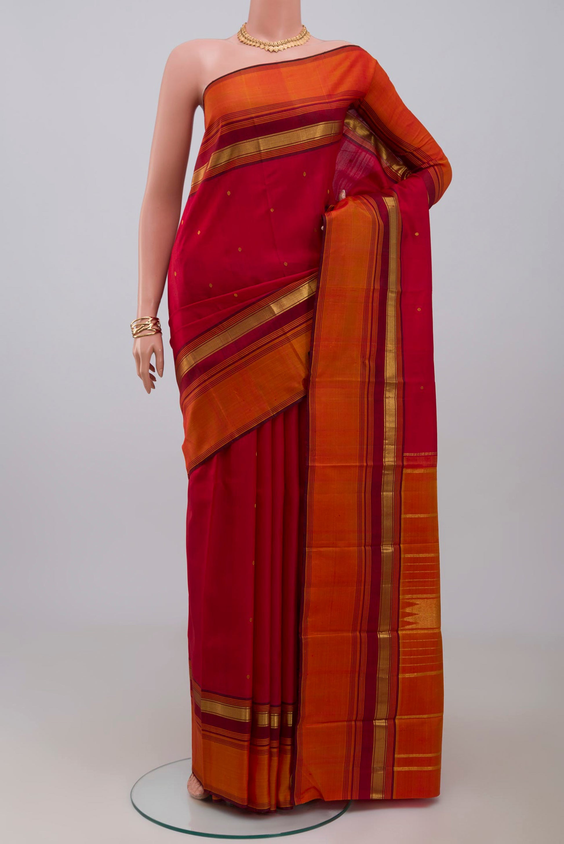 Pure Silk Pure Zari Maroon Kanchipuram Saree with Zari Butta on the body and Zari Border.  displayed on a mannequin