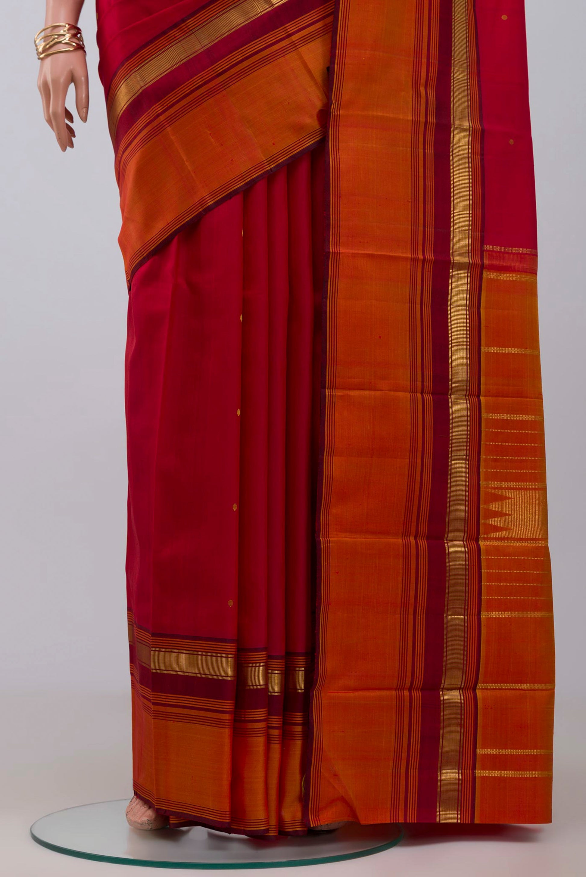 Pleats and pallu of Pure Silk Pure Zari Maroon Kanchipuram Saree with Zari Butta on the body and Zari Border. 