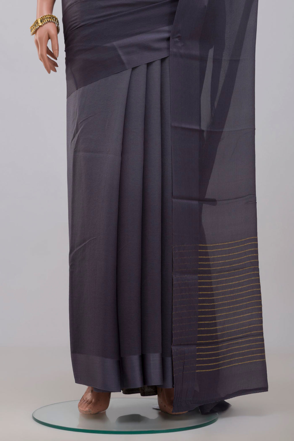 Pleats and pallu of Grey Chiffon Saree with Plain Body and Plain Border. 