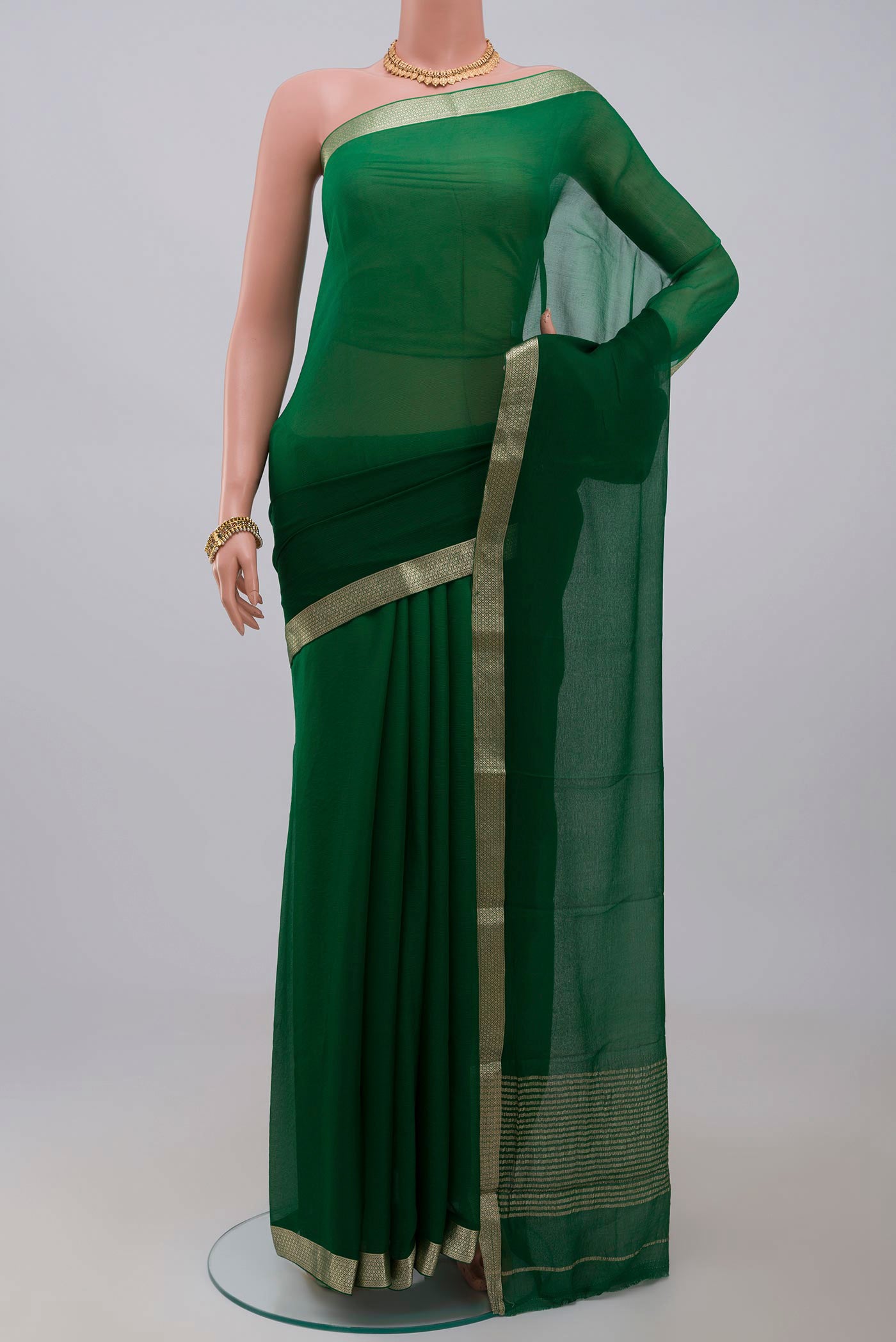 Green Chiffon Saree with Plain Body and Zari Border.  displayed on a mannequin