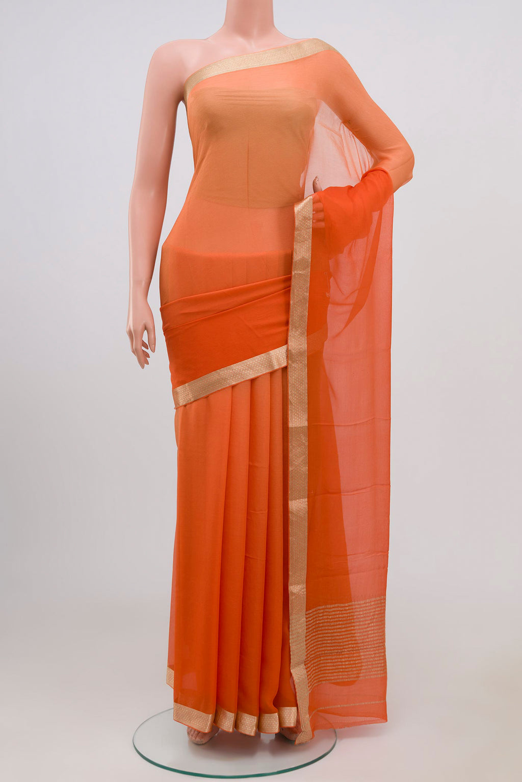 Orange Chiffon Saree with Plain Body and Zari Border.  displayed on a mannequin