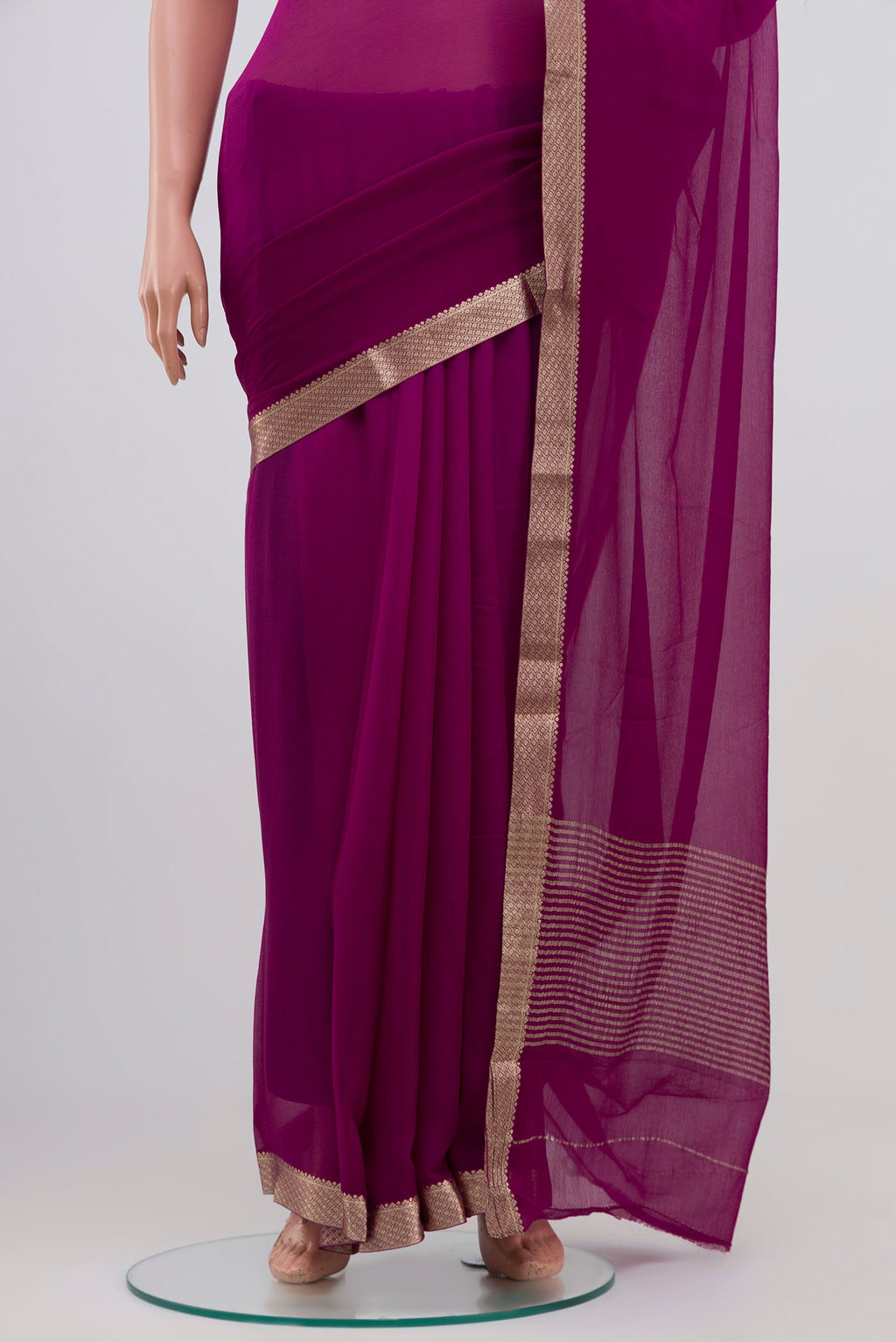 Pleats and pallu of Purple Chiffon Saree with Plain Body and Zari Border. 