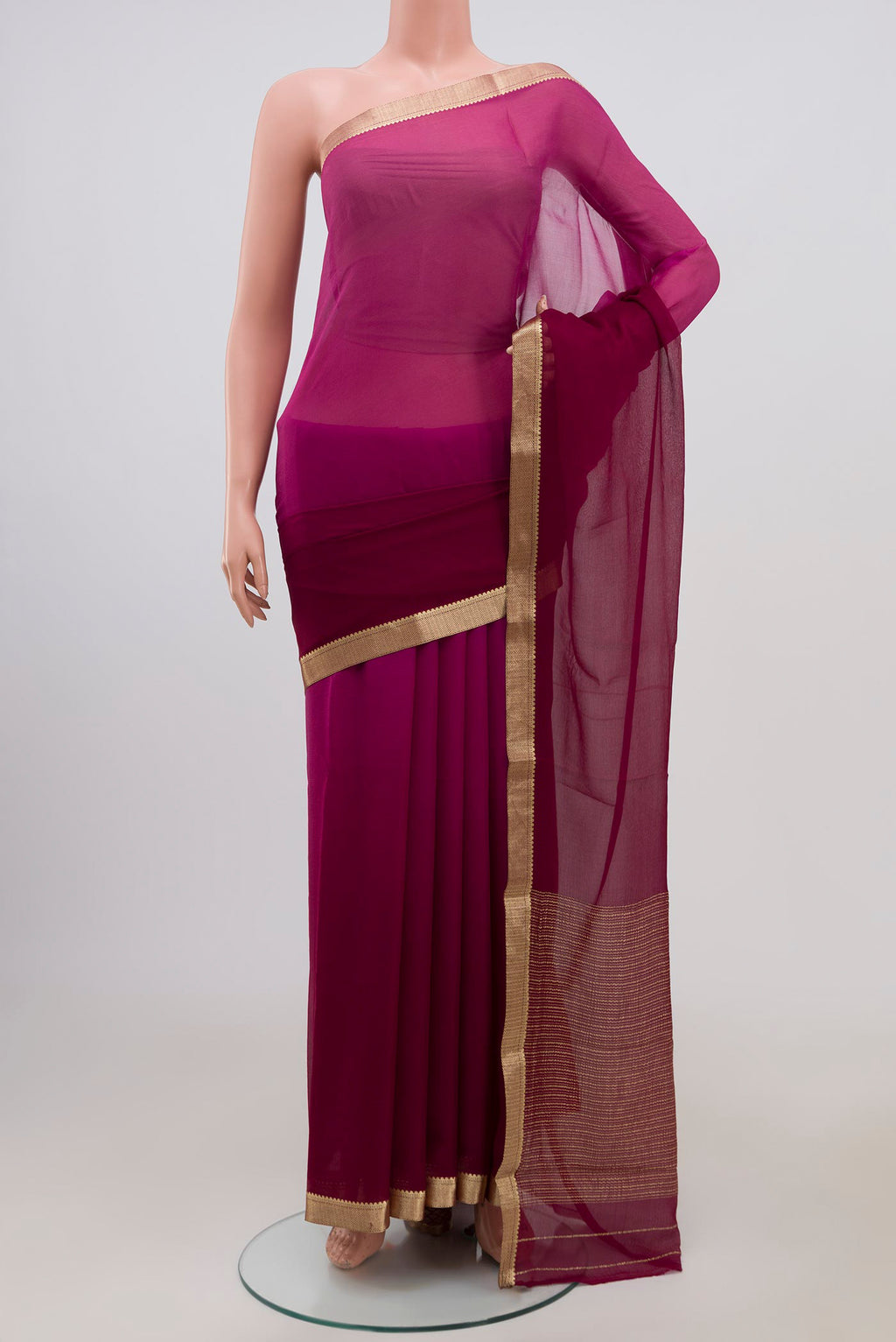 Magenta Chiffon Saree with Fancy on the body and Zari Border.  displayed on a mannequin
