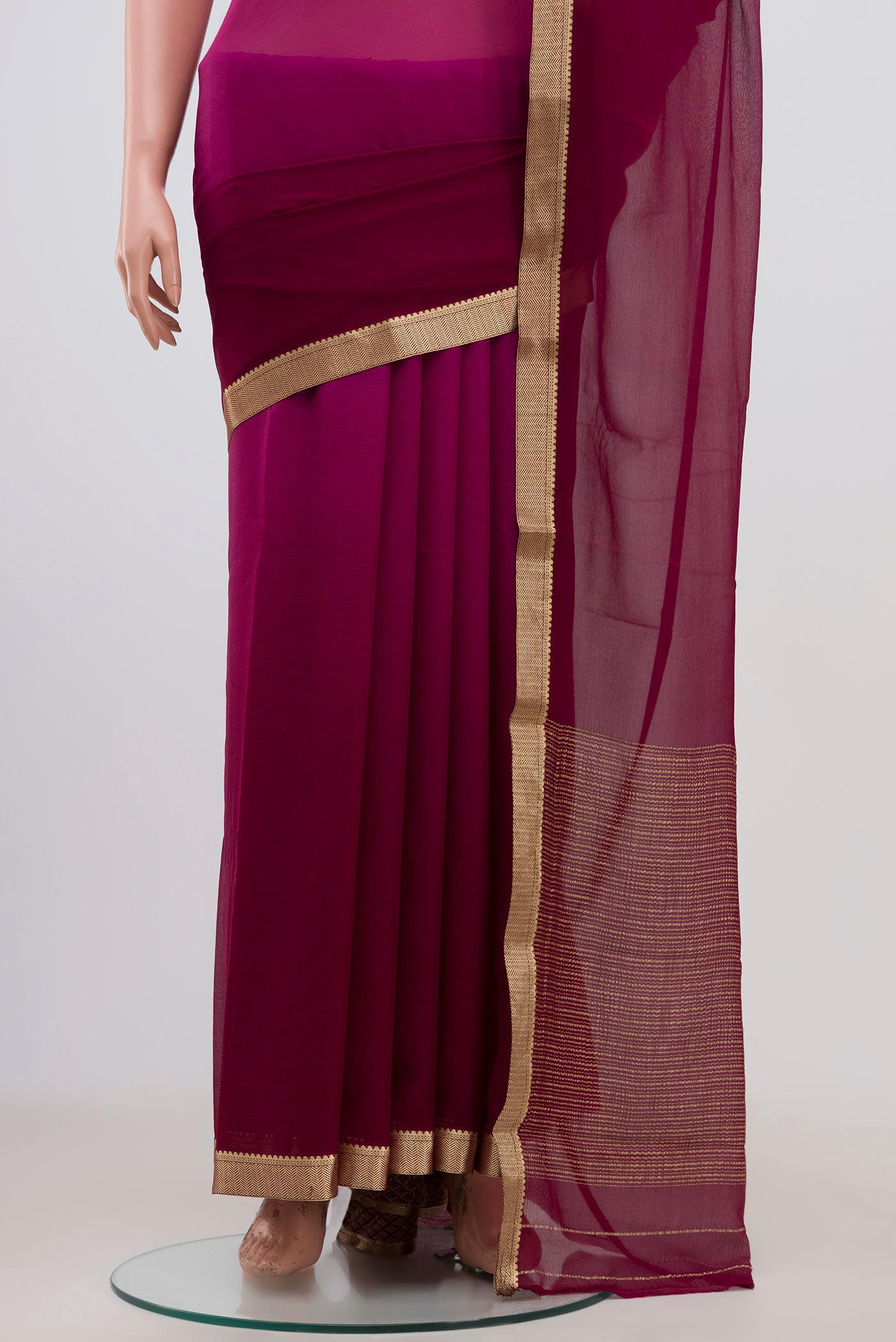 Pleats and pallu of Magenta Chiffon Saree with Fancy on the body and Zari Border. 