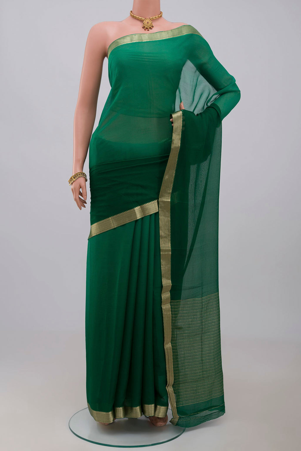 Green Chiffon Saree with Plain Body and Zari Border.  displayed on a mannequin