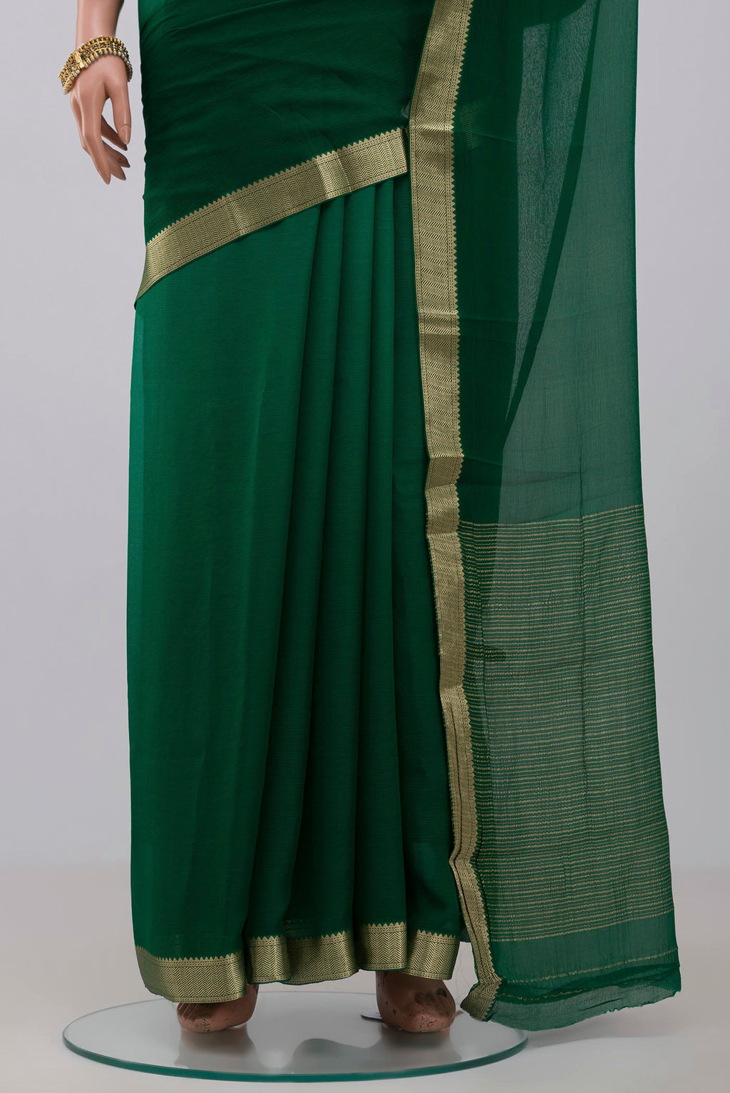 Pleats and pallu of Green Chiffon Saree with Plain Body and Zari Border. 