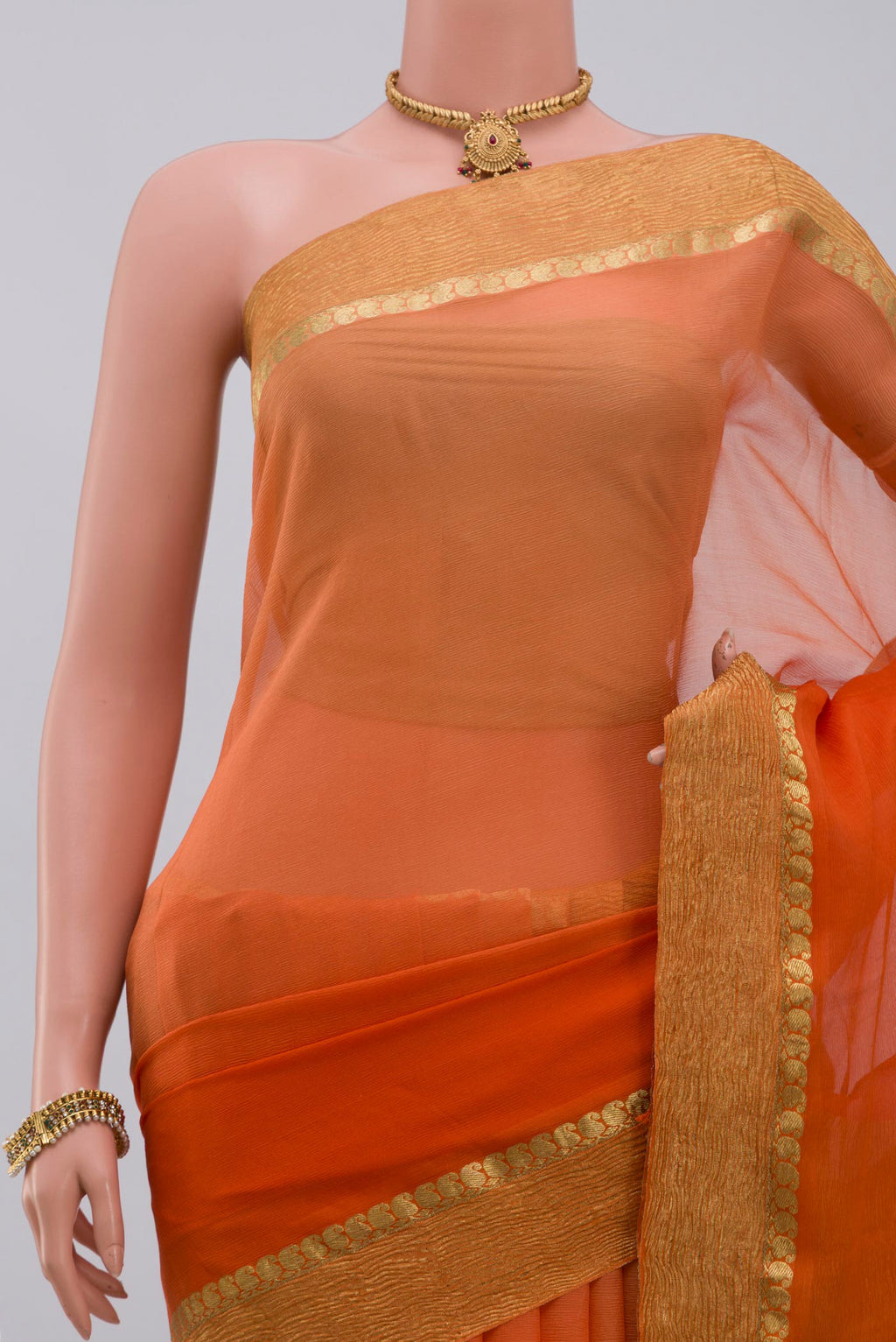 Border image of Orange Chiffon Saree with Plain Body and Zari Border. 