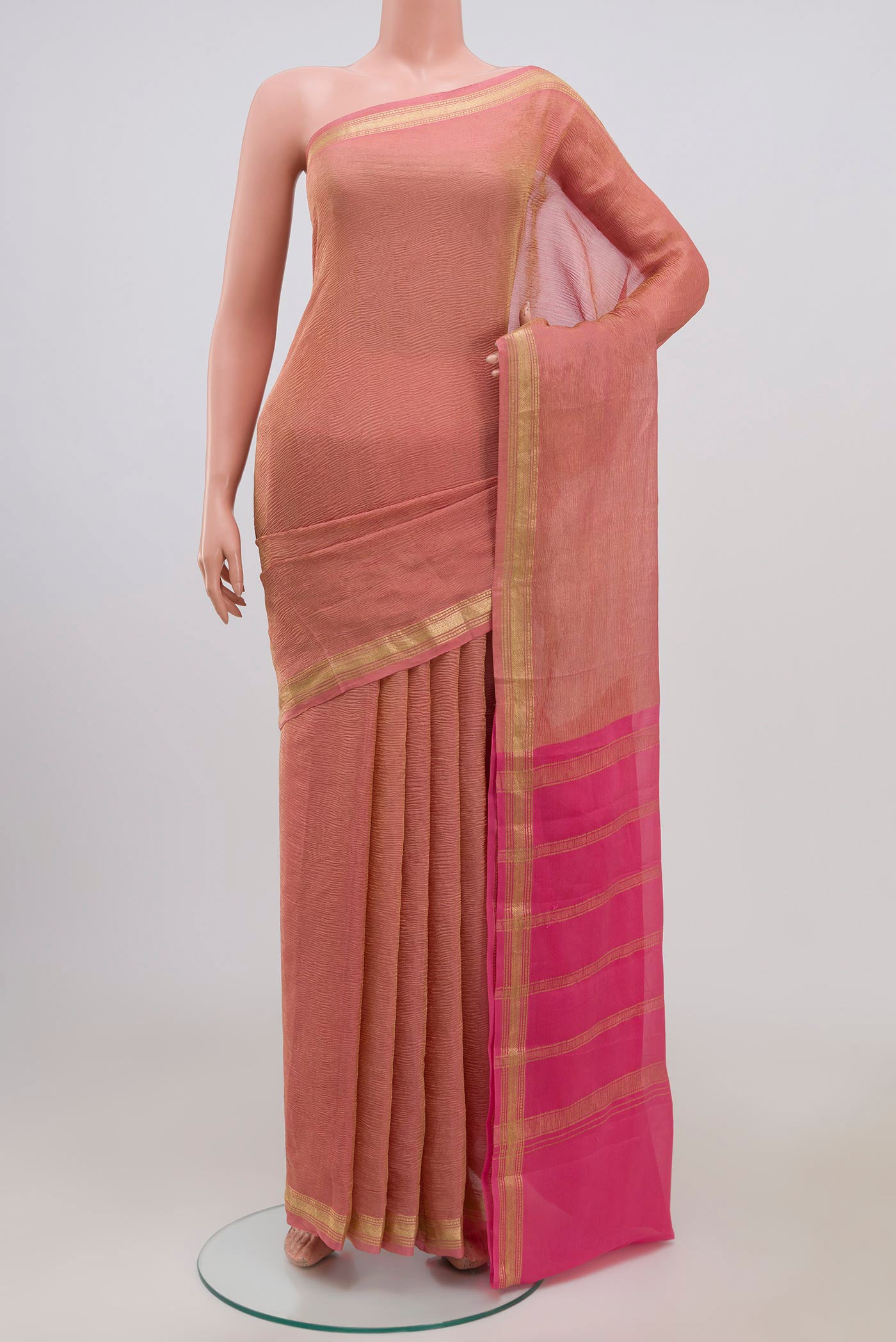 Pink Chiffon Saree with Fancy on the body and Zari Border.  displayed on a mannequin
