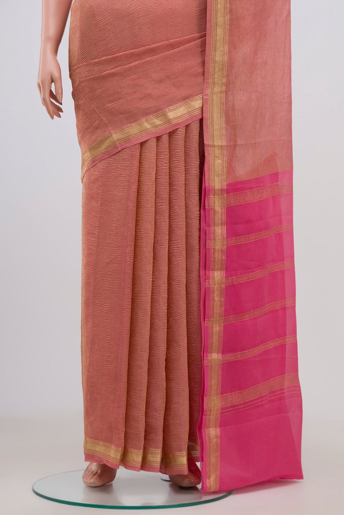 Pleats and pallu of Pink Chiffon Saree with Fancy on the body and Zari Border. 