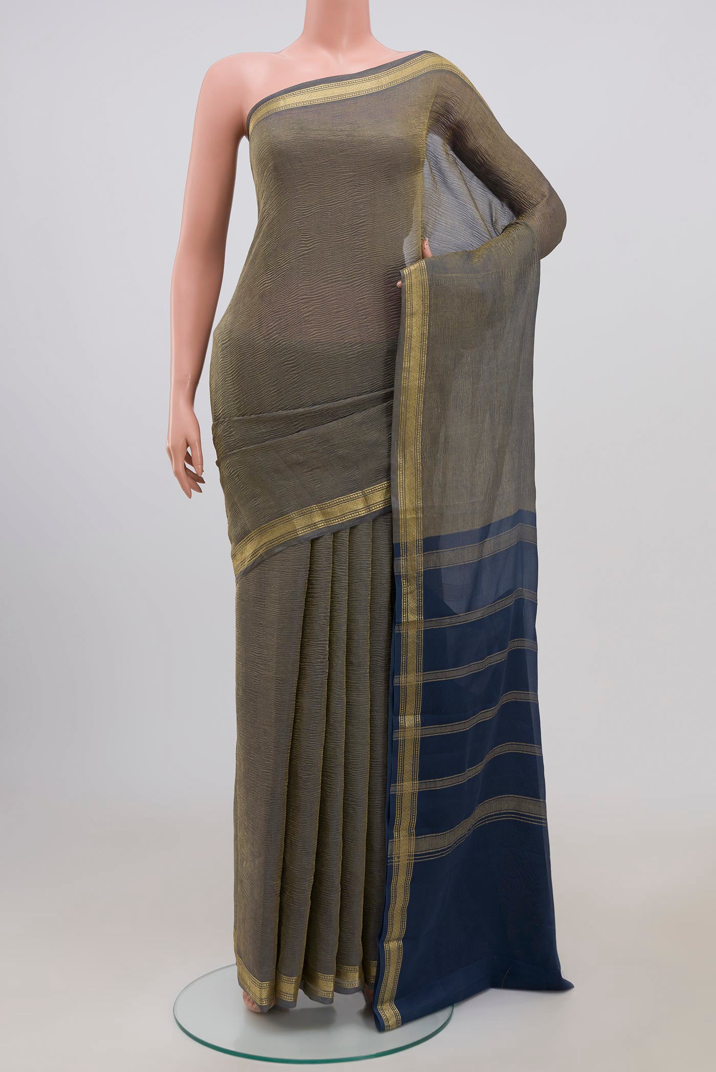 Blue Grey Chiffon Saree with Fancy on the body and Zari Border.  displayed on a mannequin