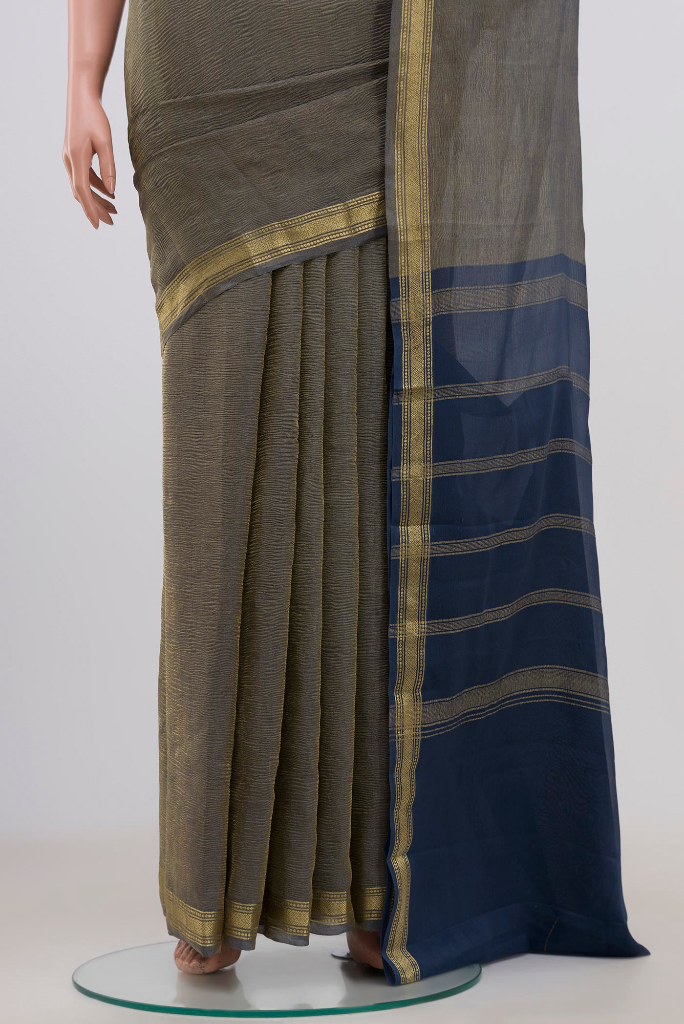 Pleats and pallu of Blue Grey Chiffon Saree with Fancy on the body and Zari Border. 