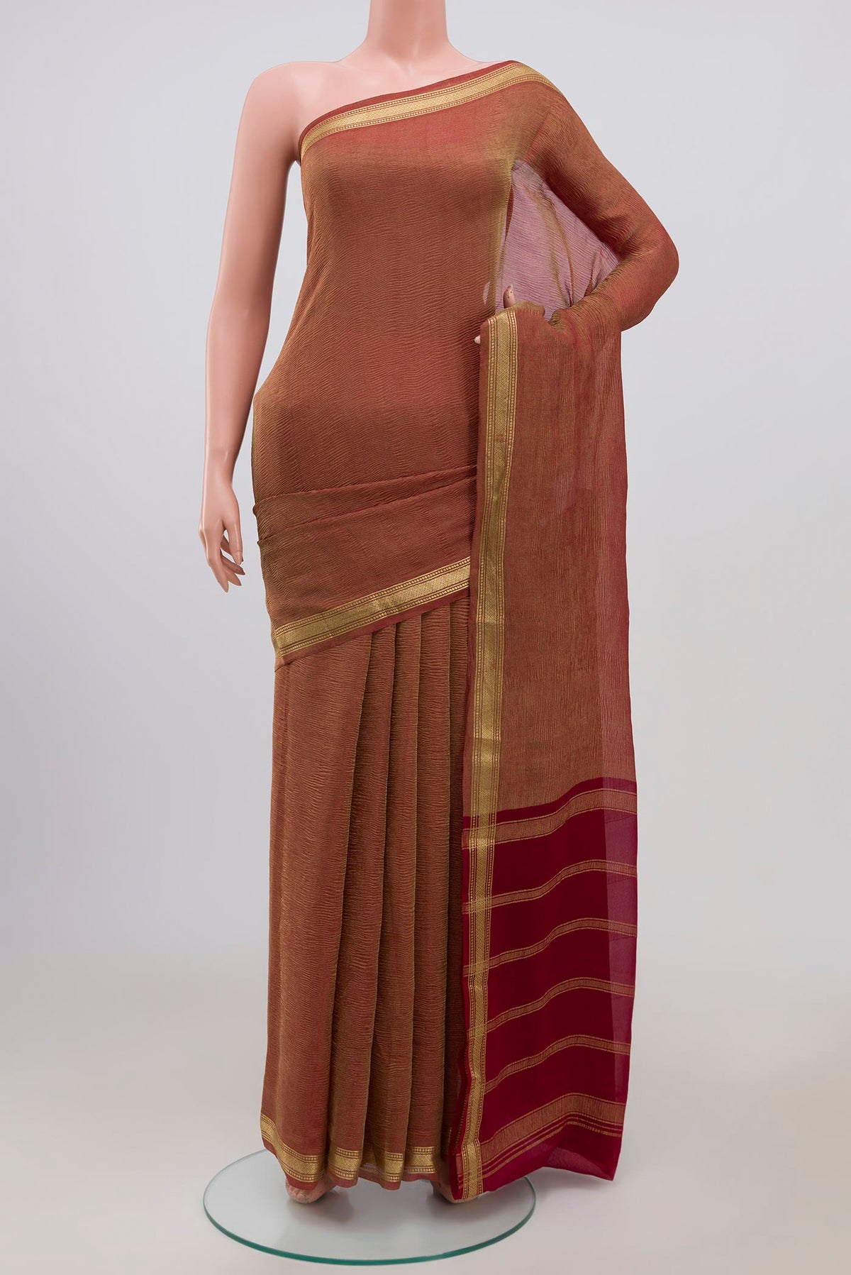 Maroon Chiffon Saree with Fancy on the body and Zari Border.  displayed on a mannequin