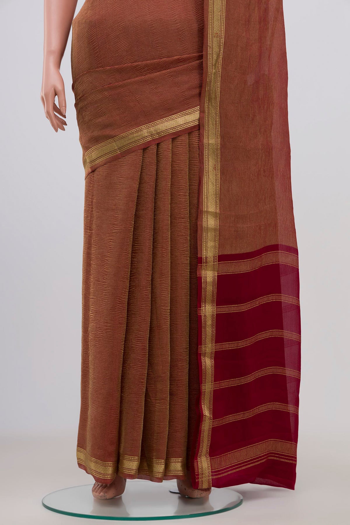 Pleats and pallu of Maroon Chiffon Saree with Fancy on the body and Zari Border. 