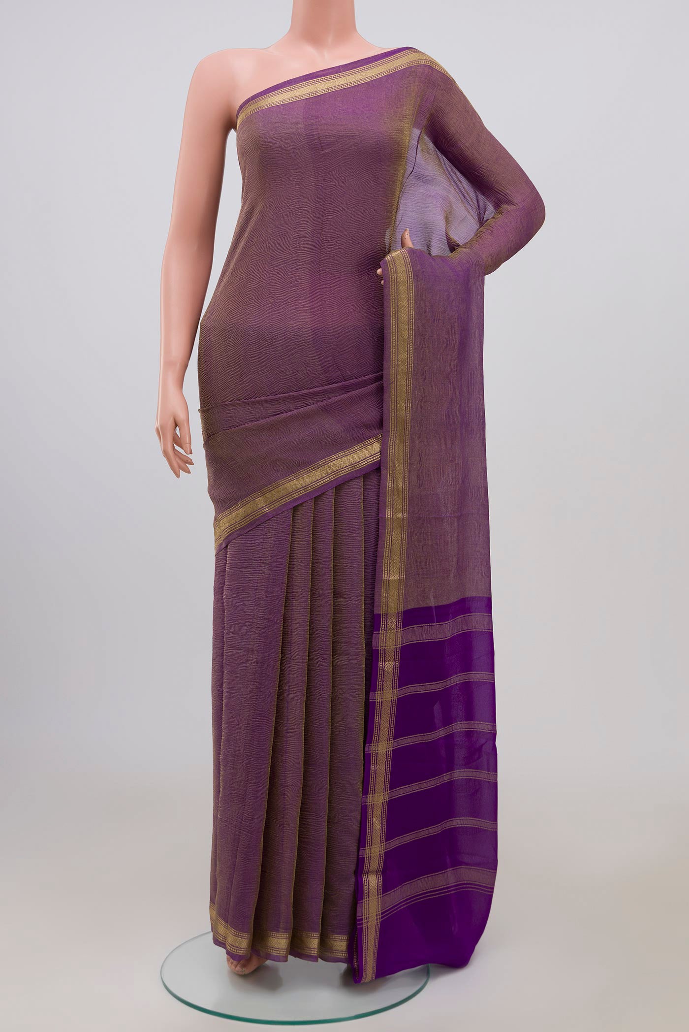 Purple Chiffon Saree with Fancy on the body and Zari Border.  displayed on a mannequin