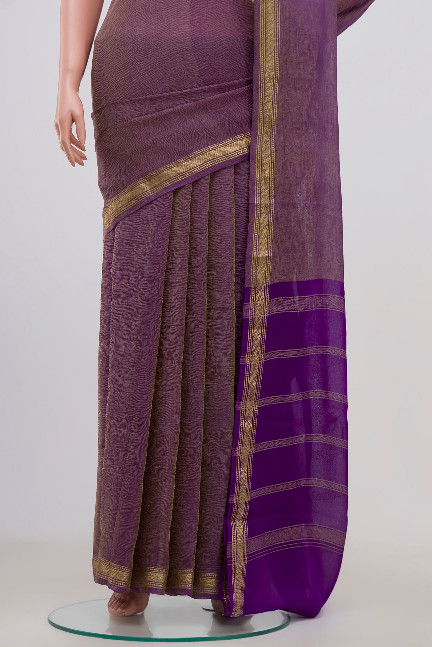 Pleats and pallu of Purple Chiffon Saree with Fancy on the body and Zari Border. 
