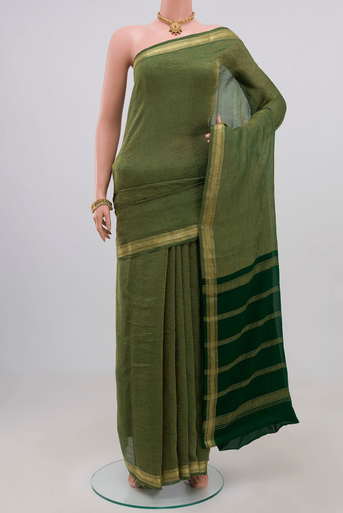 Green Chiffon Saree with Plain Body and Zari Border.  displayed on a mannequin