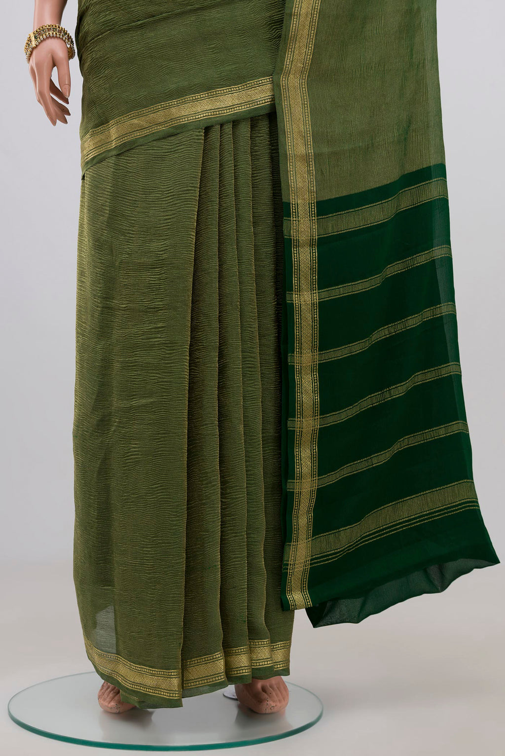 Pleats and pallu of Green Chiffon Saree with Plain Body and Zari Border. 