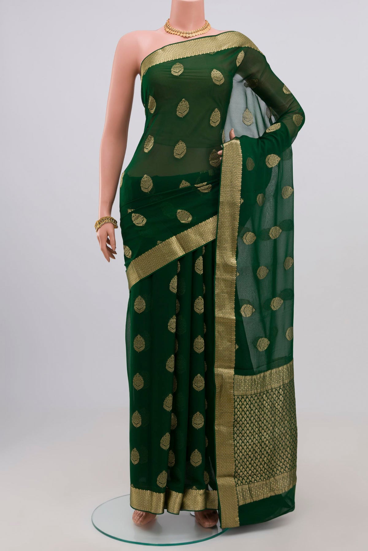 Green Georgette Saree with Fancy on the body and Zari Border.  displayed on a mannequin