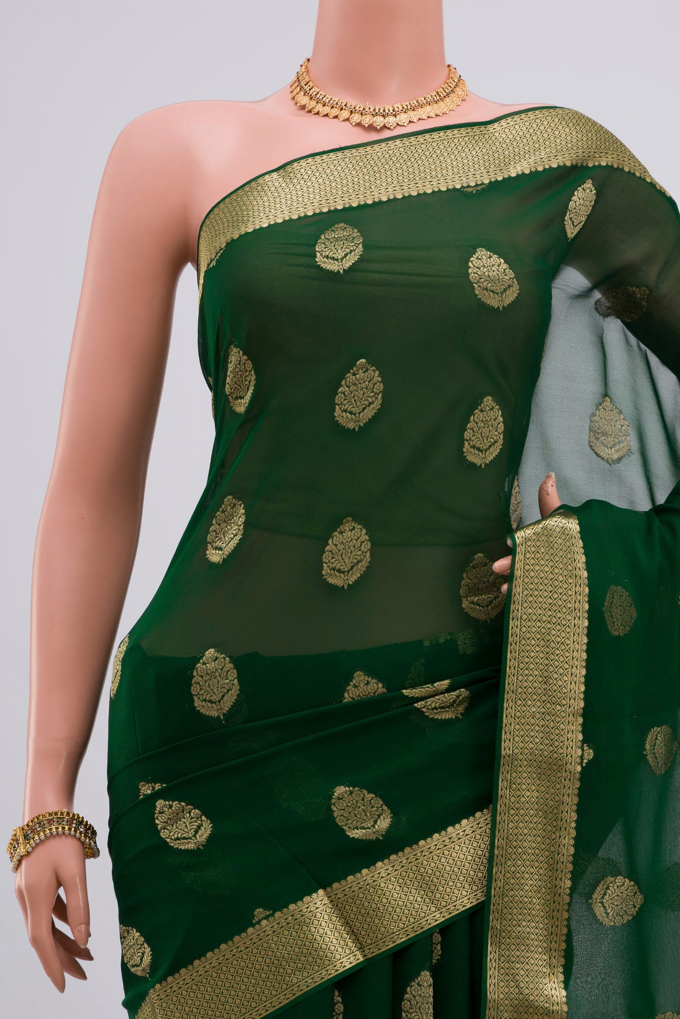 Pleats and pallu of Green Georgette Saree with Fancy on the body and Zari Border. 