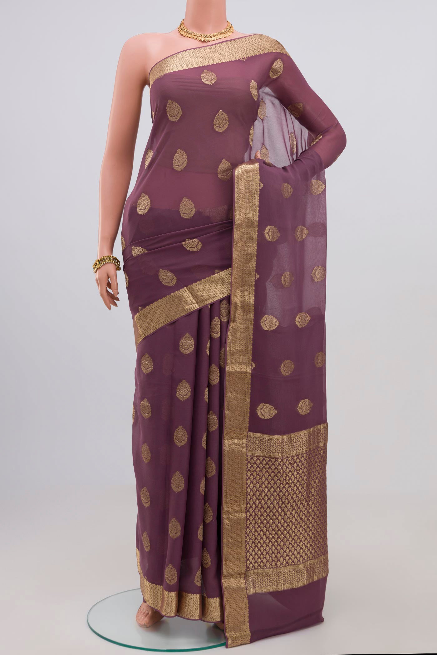 Lavender Georgette Saree with Fancy on the body and Zari Border.  displayed on a mannequin