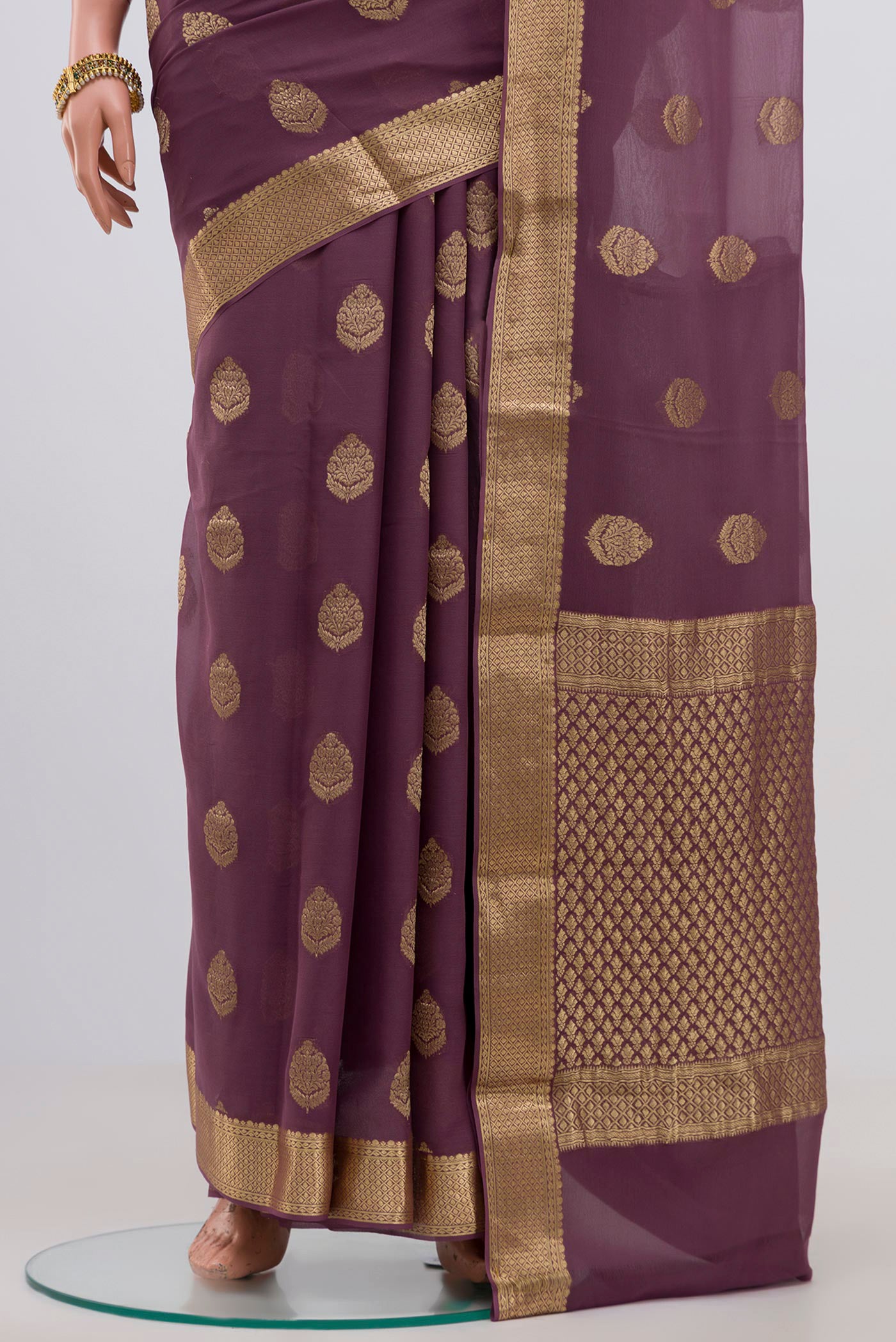 Pleats and pallu of Lavender Georgette Saree with Fancy on the body and Zari Border. 